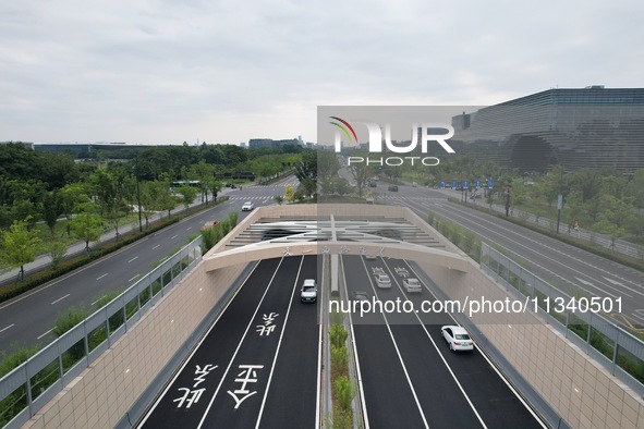 Vehicles are passing through the Wenyi West Road tunnel in Hangzhou, China, on June 18, 2024. 