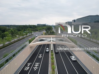 Vehicles are passing through the Wenyi West Road tunnel in Hangzhou, China, on June 18, 2024. (