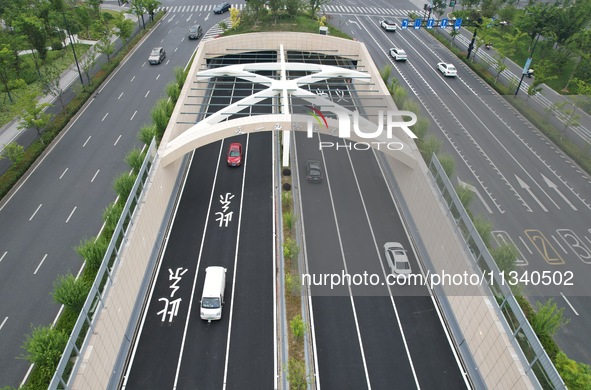 Vehicles are passing through the Wenyi West Road tunnel in Hangzhou, China, on June 18, 2024. 