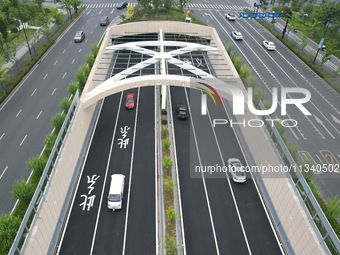 Vehicles are passing through the Wenyi West Road tunnel in Hangzhou, China, on June 18, 2024. (