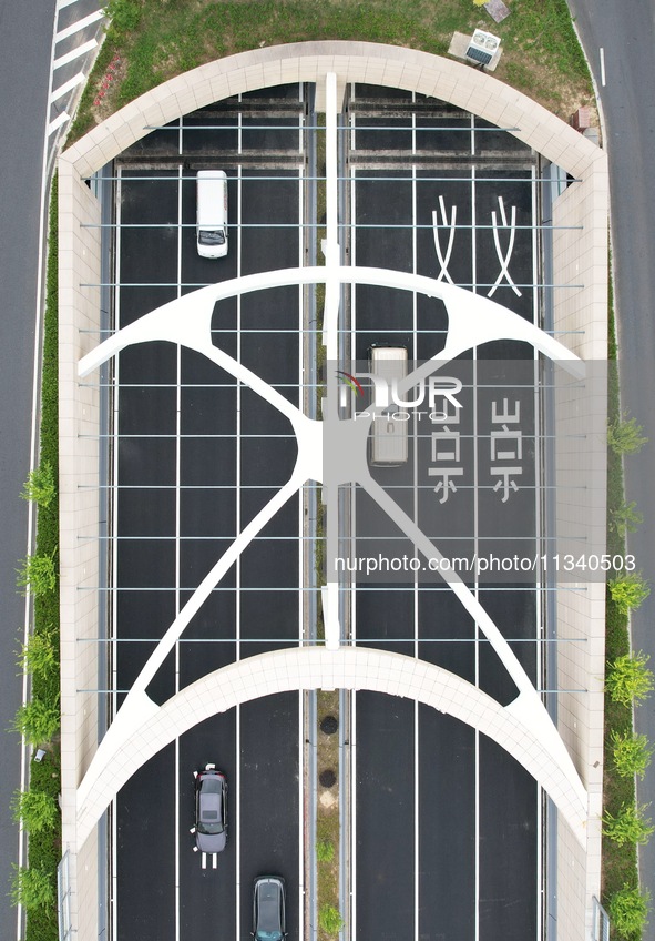 Vehicles are passing through the Wenyi West Road tunnel in Hangzhou, China, on June 18, 2024. 