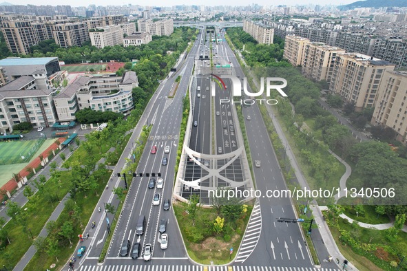 Vehicles are passing through the Wenyi West Road tunnel in Hangzhou, China, on June 18, 2024. 