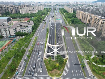 Vehicles are passing through the Wenyi West Road tunnel in Hangzhou, China, on June 18, 2024. (