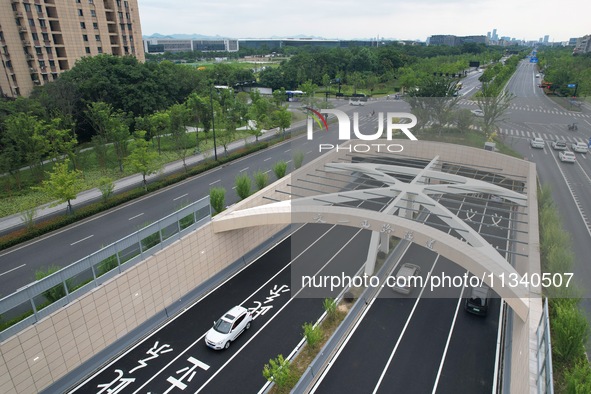 Vehicles are passing through the Wenyi West Road tunnel in Hangzhou, China, on June 18, 2024. 