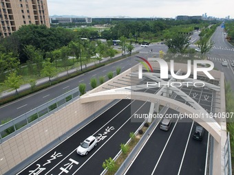 Vehicles are passing through the Wenyi West Road tunnel in Hangzhou, China, on June 18, 2024. (