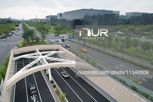 Vehicles are passing through the Wenyi West Road tunnel in Hangzhou, China, on June 18, 2024. 