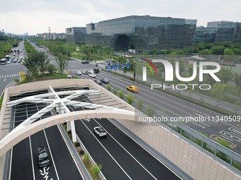 Vehicles are passing through the Wenyi West Road tunnel in Hangzhou, China, on June 18, 2024. (