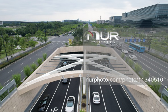 Vehicles are passing through the Wenyi West Road tunnel in Hangzhou, China, on June 18, 2024. 