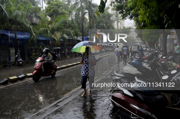 A pedestrian is carrying an umbrella during rainfall in Mumbai, India, on June 18, 2024. 