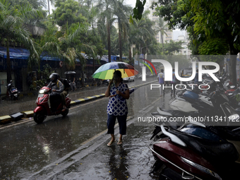 A pedestrian is carrying an umbrella during rainfall in Mumbai, India, on June 18, 2024. (