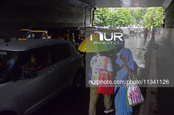 A pedestrian is carrying an umbrella during rainfall in Mumbai, India, on June 18, 2024. 