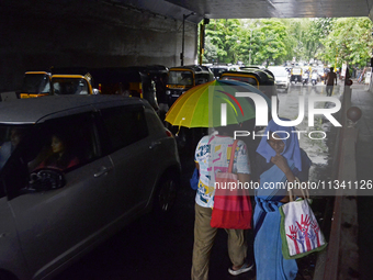 A pedestrian is carrying an umbrella during rainfall in Mumbai, India, on June 18, 2024. (