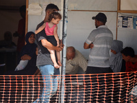 People are waiting inside the UK-Med hospital in southern Gaza, which is being set up to try to meet what it is describing as an ''overwhelm...