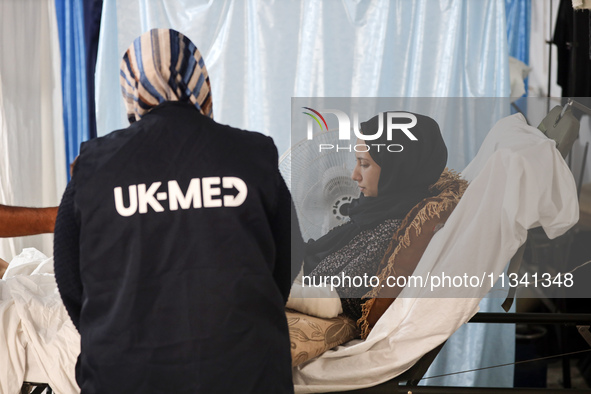 An injured person is lying inside the UK-Med hospital in southern Gaza, which is being set up to try to meet what it describes as an ''overw...