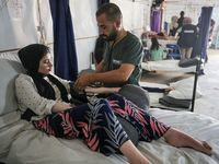 An injured person is lying inside the UK-Med hospital in southern Gaza, which is being set up to try to meet what it describes as an ''overw...