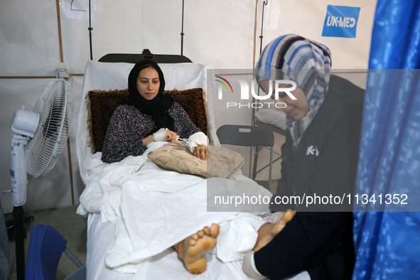 An injured person is lying inside the UK-Med hospital in southern Gaza, which is being set up to try to meet what it describes as an ''overw...