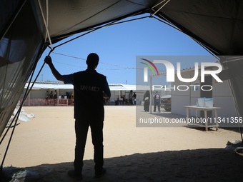 People are waiting inside the UK-Med hospital in southern Gaza, which is being set up to try to meet what it is describing as an ''overwhelm...