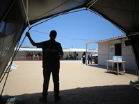 People are waiting inside the UK-Med hospital in southern Gaza, which is being set up to try to meet what it is describing as an ''overwhelm...