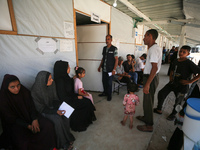 People are waiting inside the UK-Med hospital in southern Gaza, which is being set up to try to meet what it is describing as an ''overwhelm...