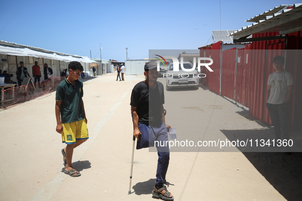 People are walking at the UK-Med hospital in southern Gaza, which has been set up to try to meet what it describes as an ''overwhelming'' de...