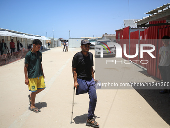 People are walking at the UK-Med hospital in southern Gaza, which has been set up to try to meet what it describes as an ''overwhelming'' de...