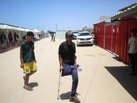 People are walking at the UK-Med hospital in southern Gaza, which has been set up to try to meet what it describes as an ''overwhelming'' de...