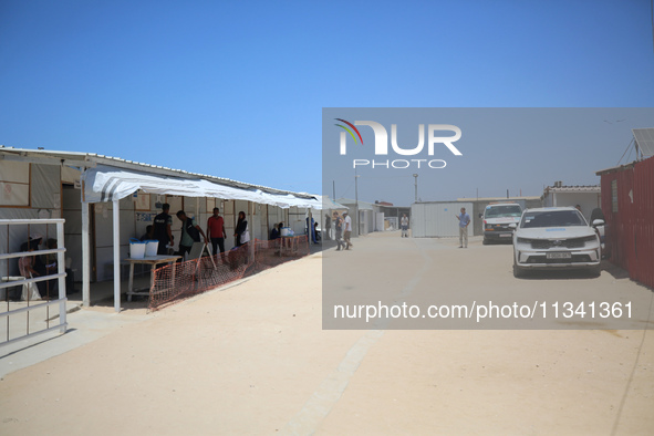 People are walking at the UK-Med hospital in southern Gaza, which has been set up to try to meet what it describes as an ''overwhelming'' de...