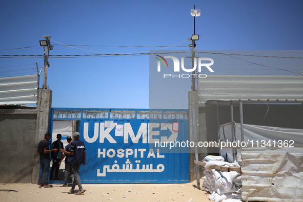 People are walking at the UK-Med hospital in southern Gaza, which has been set up to try to meet what it describes as an ''overwhelming'' de...