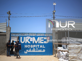 People are walking at the UK-Med hospital in southern Gaza, which has been set up to try to meet what it describes as an ''overwhelming'' de...