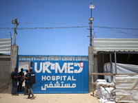 People are walking at the UK-Med hospital in southern Gaza, which has been set up to try to meet what it describes as an ''overwhelming'' de...