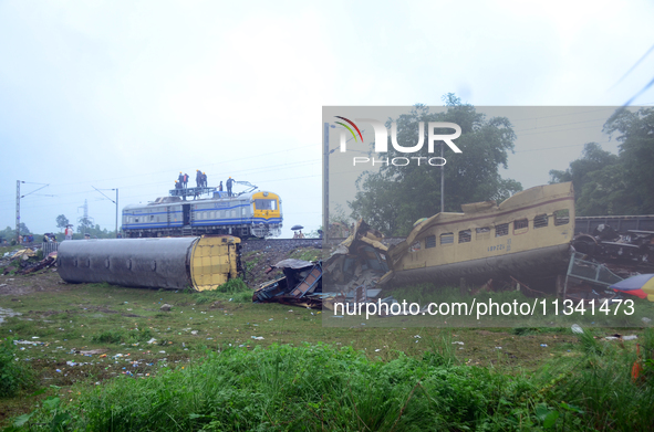 Railway staff, workers, and police force are being seen at the site as they are restoring the train service at the tracks after a collision...