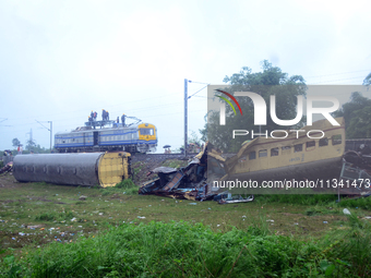 Railway staff, workers, and police force are being seen at the site as they are restoring the train service at the tracks after a collision...