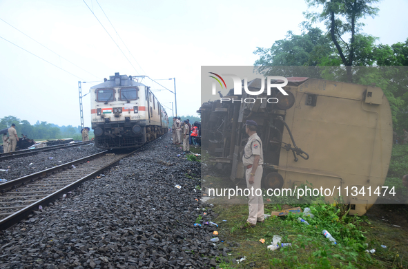 Railway staff, workers, and police force are being seen at the site as they are restoring the train service at the tracks after a collision...