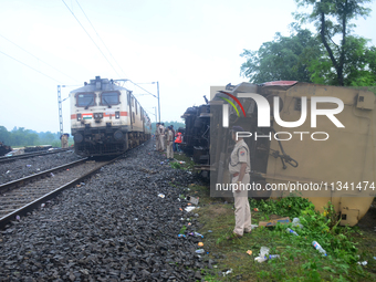 Railway staff, workers, and police force are being seen at the site as they are restoring the train service at the tracks after a collision...