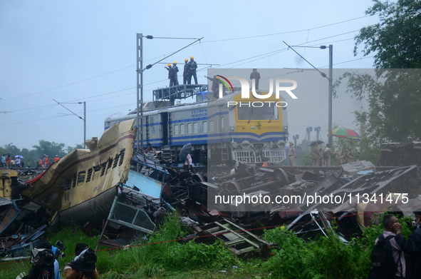 Railway staff, workers, and police force are being seen at the site as they are restoring the train service at the tracks after a collision...