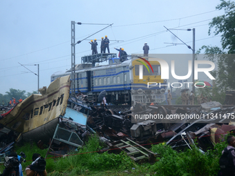 Railway staff, workers, and police force are being seen at the site as they are restoring the train service at the tracks after a collision...