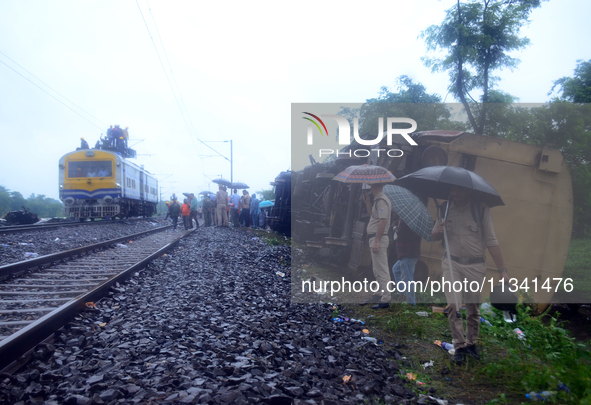 Railway staff, workers, and police force are being seen at the site as they are restoring the train service at the tracks after a collision...