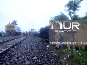 Railway staff, workers, and police force are being seen at the site as they are restoring the train service at the tracks after a collision...