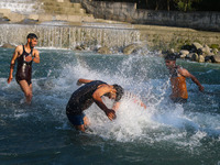 Men are taking a bath in a stream on a sunny day in Kangan, about 70kms from Srinagar, on June 18, 2024. (