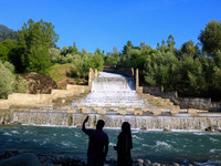 A couple is taking a selfie near the Barwalla waterfall in Kangan, about 70kms from Srinagar, on June 18, 2024. (