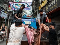 Workers are carrying rawhide from sacrificial cattle to a local factory for preservation by sprinkling salt, a day after Eid-ul-Adha, known...