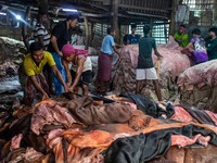 Workers are carrying rawhide from sacrificial cattle to a local factory for preservation by sprinkling salt, a day after Eid-ul-Adha, known...