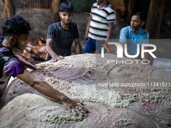 Workers are carrying rawhide from sacrificial cattle to a local factory for preservation by sprinkling salt, a day after Eid-ul-Adha, known...