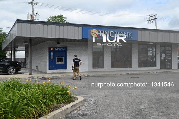 FBI agents are responding to PNC Bank in Chicago, Illinois, because of a bank robbery. Two suspects are being captured, and money and a hand...