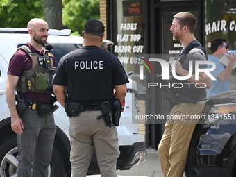 FBI agents and Chicago Police are on the scene on W. Belmont Av. where the vehicles are being recovered, with one vehicle containing a black...