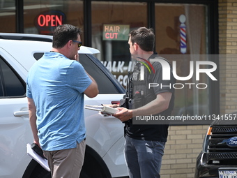 FBI agents and Chicago Police are responding to the scene on W. Belmont Ave. where two vehicles are being recovered that were used in the ba...