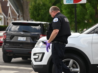 The Crime Scene Unit is recovering a handgun from a vehicle used in the bank robbery. Two suspects are being captured, and money and a handg...