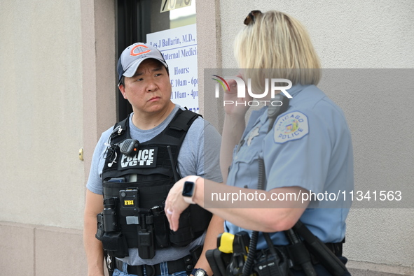 FBI agent and Chicago Police officer are at the scene on W. Belmont Av. where two vehicles are being recovered that were used in the bank ro...