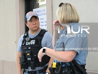 FBI agent and Chicago Police officer are at the scene on W. Belmont Av. where two vehicles are being recovered that were used in the bank ro...