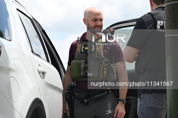 An FBI agent is at the scene on W. Belmont Ave. where two vehicles are being recovered that were used in the bank robbery. Two suspects are...